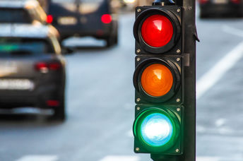 繁忙的十字路口的交通信号灯，行人过境和汽车。