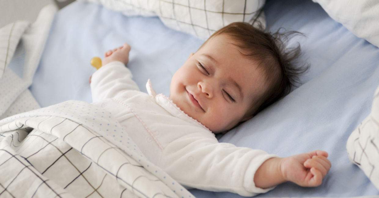 微笑的婴儿躺在床上睡觉